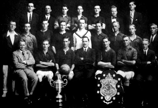 Stella Football Club - 1922 (Dewar Shield and Charity Cup Winners) Back Row: E.R. Brokensha; R. Moore; C. Stephenson; S. Martyn; L. MacRae; C. Tucker; R. Cutbush. Standing: F. Scoones; A.V. Harrison; A.W. Scoones; H. Davis; R. Scoones; H. Millyard; Herbert Clark; C. Roper; S. Veckranges. Seated: William "W.T." Clark; A Hutchinson; Edgar Clark (Captain); W.H. Sperryn (President); V. Clarkson (Vice Captain); Alfred Clark; A. Williams
